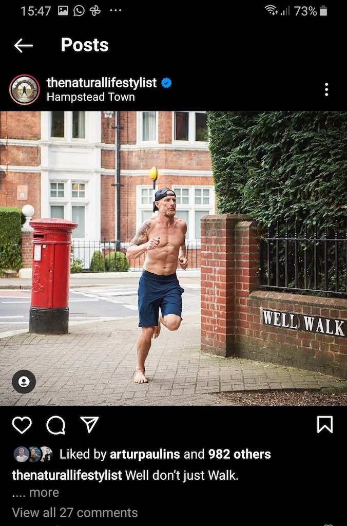 A man running through the city streets topless