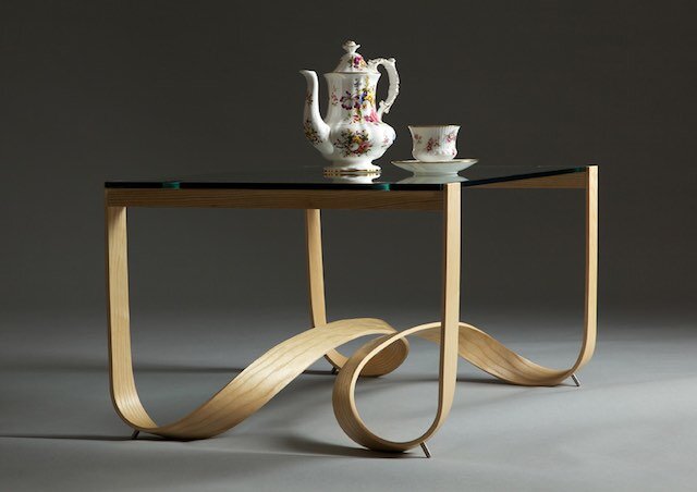 A stylish ribbon coffee table with a tea set on top