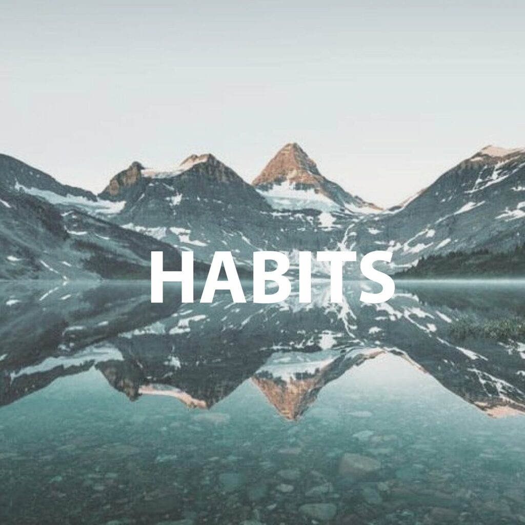 A stunning mountain landscape reflected in a lake, labeled "HABITS."