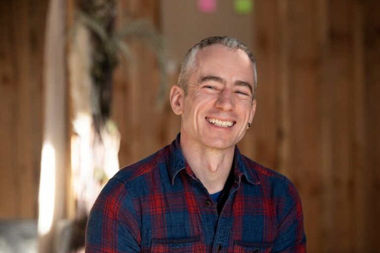 Half body shot of James O'Halloran smiling at the camera