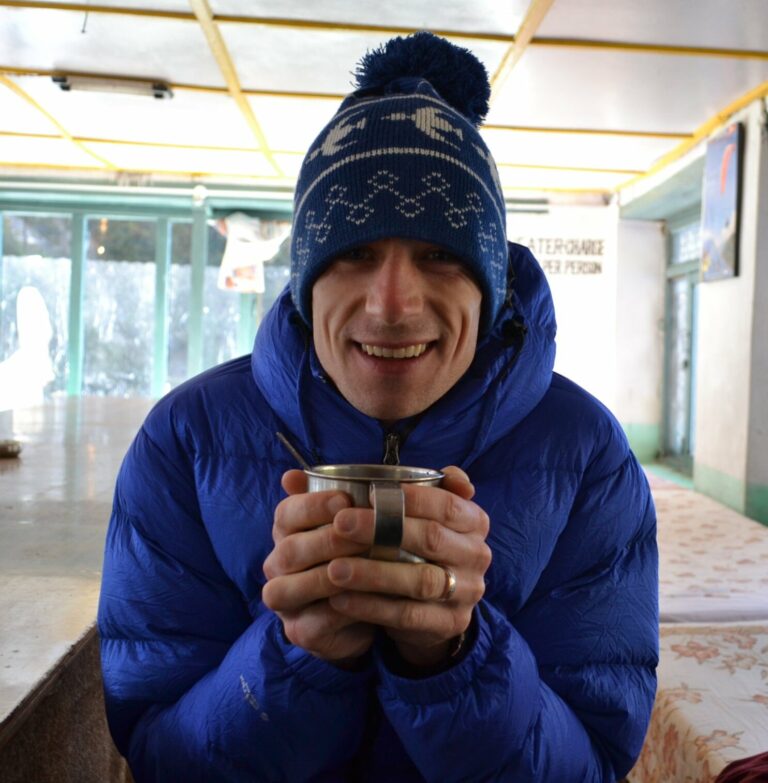 James O'Halloran in a winter coat holding a mug.